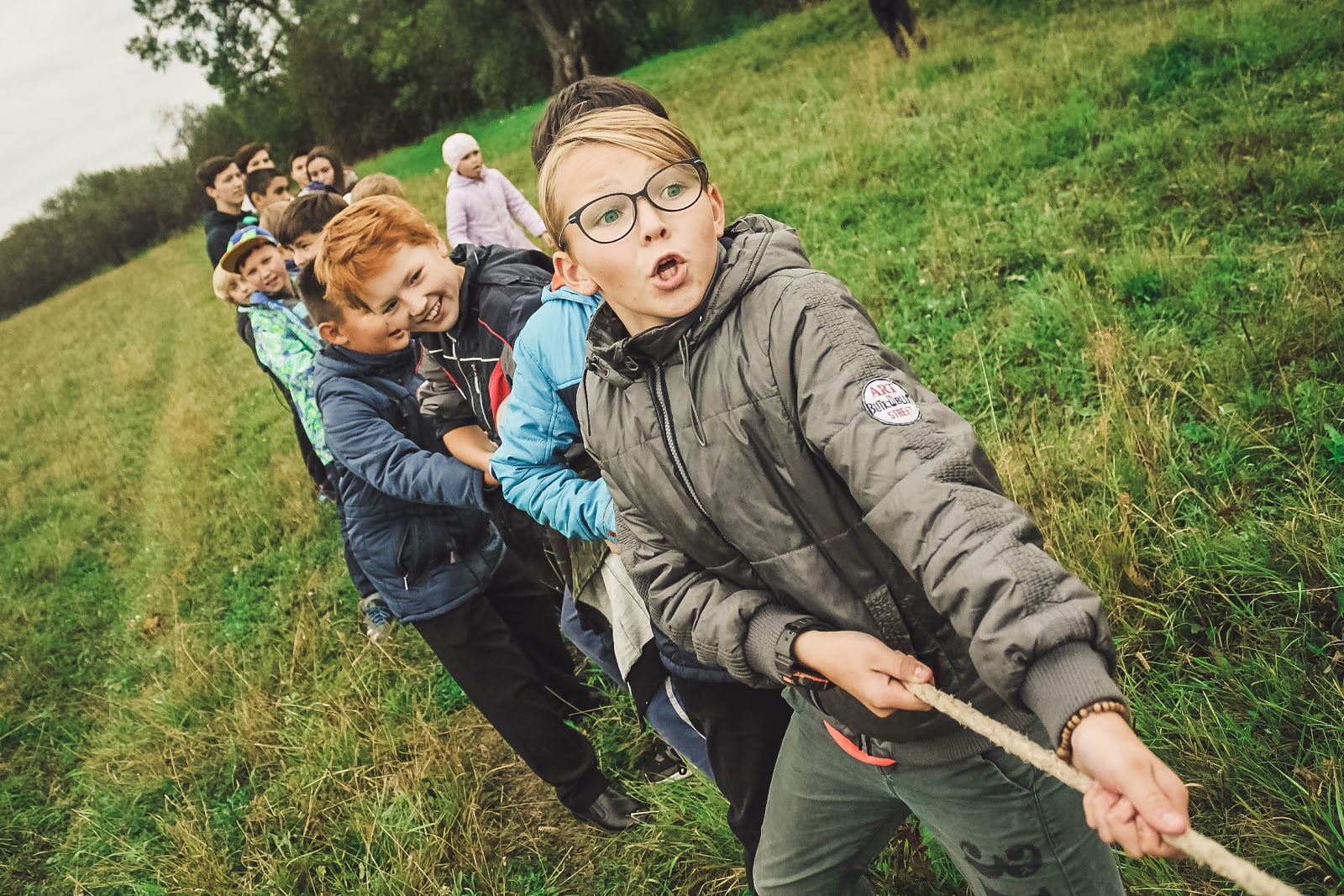 An example image that goes in a donation thank you letter. A group of kids plays tug of war.